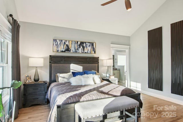 bedroom with multiple windows, vaulted ceiling, ceiling fan, and light hardwood / wood-style flooring