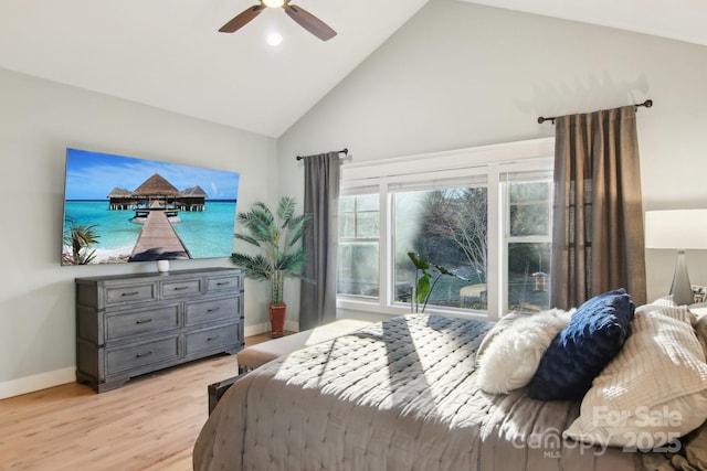 bedroom with ceiling fan, high vaulted ceiling, and light hardwood / wood-style flooring