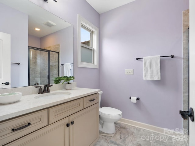 bathroom with vanity, toilet, and walk in shower