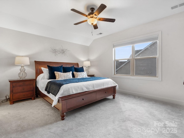 carpeted bedroom with ceiling fan and vaulted ceiling