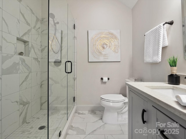 bathroom with vanity, a shower with door, and toilet