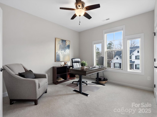 home office featuring ceiling fan and light colored carpet