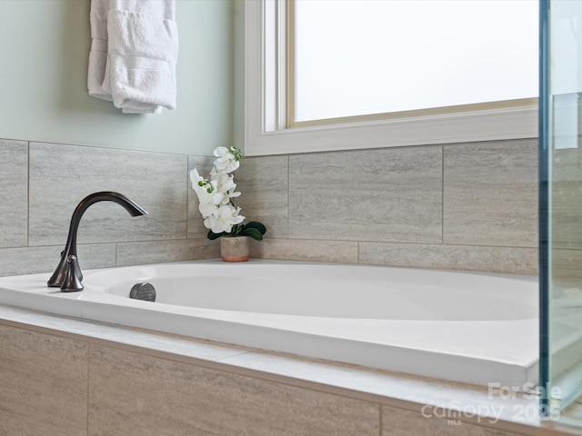 bathroom with tiled bath