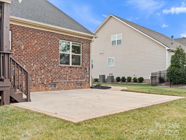 back of house featuring a yard and central AC