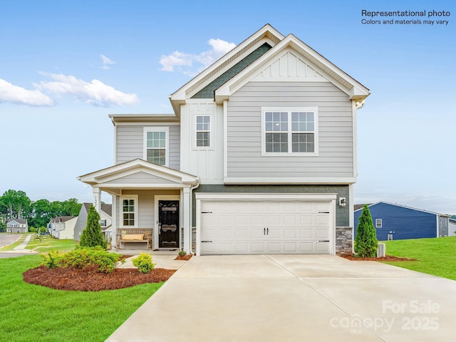 craftsman-style home with a garage, covered porch, and a front lawn