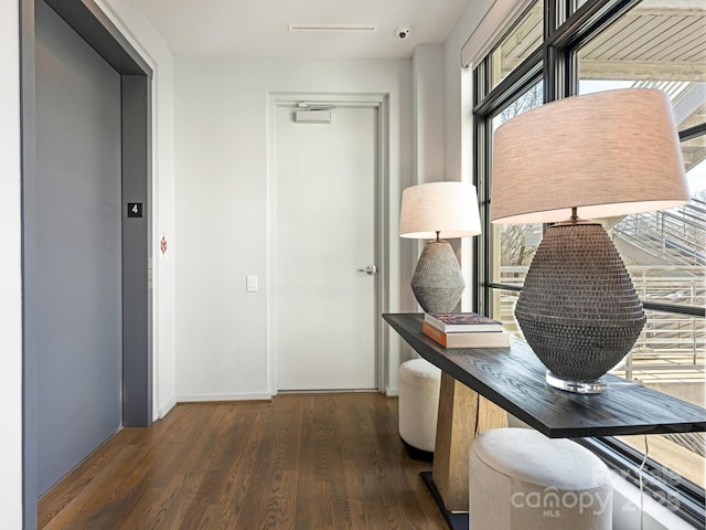 hall featuring dark hardwood / wood-style floors and elevator