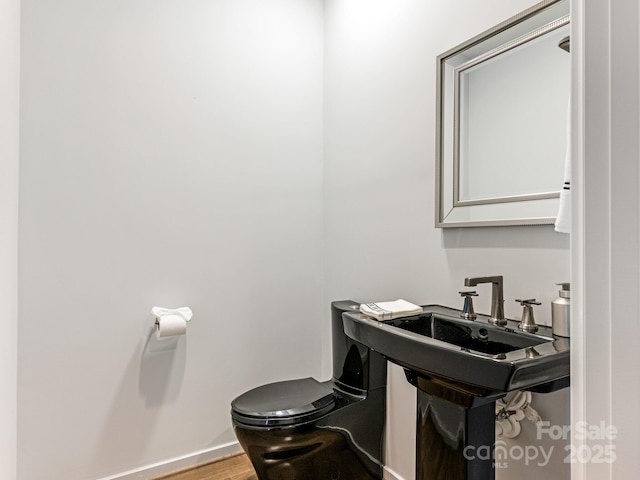 bathroom featuring hardwood / wood-style floors and toilet