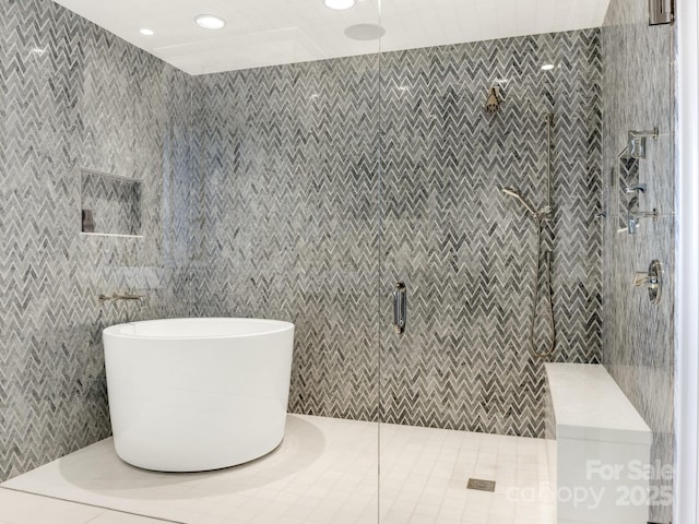 bathroom featuring tile walls, tile patterned flooring, and a shower