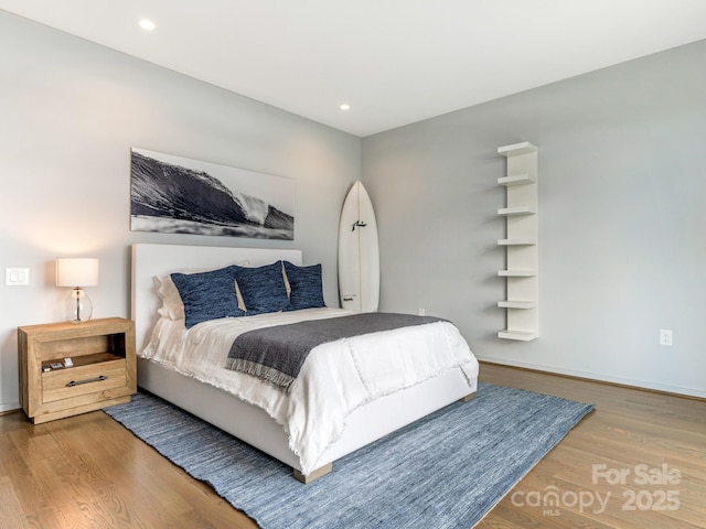 bedroom with hardwood / wood-style floors