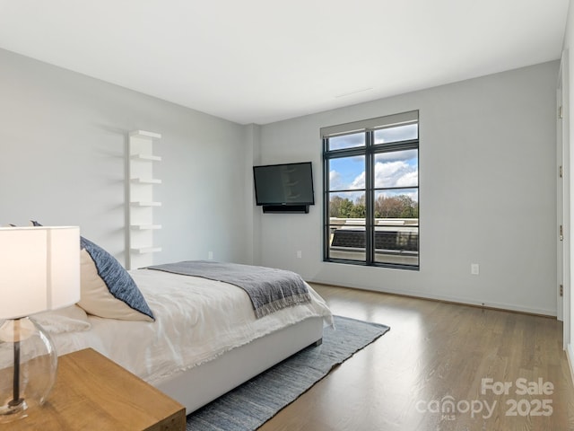 bedroom with hardwood / wood-style floors