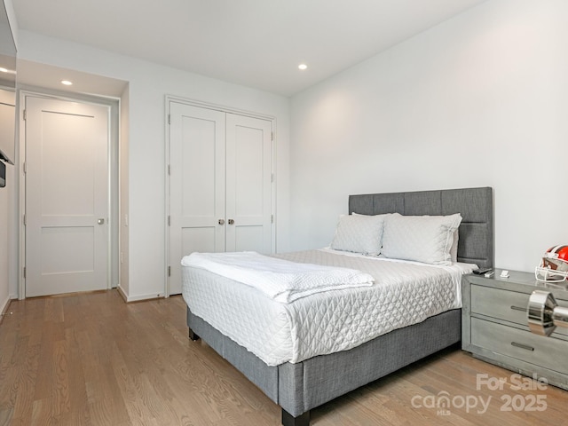 bedroom featuring light hardwood / wood-style flooring and a closet