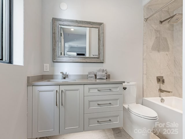 full bathroom featuring vanity, toilet, and tiled shower / bath