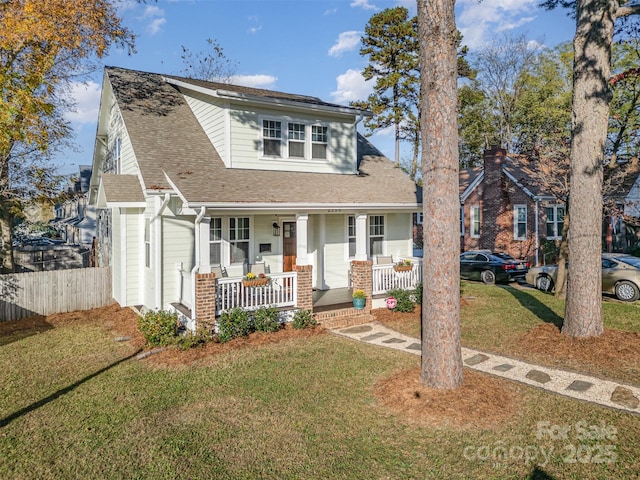 view of front facade featuring covered porch and a front yard