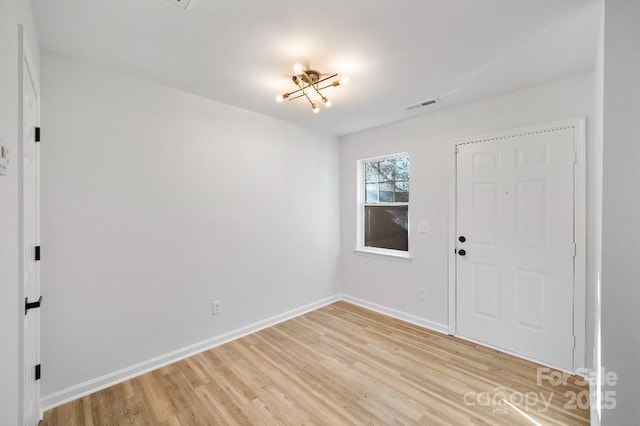 empty room with light hardwood / wood-style flooring