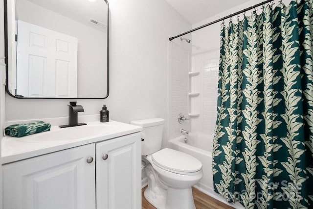 bathroom with hardwood / wood-style floors, toilet, and vanity