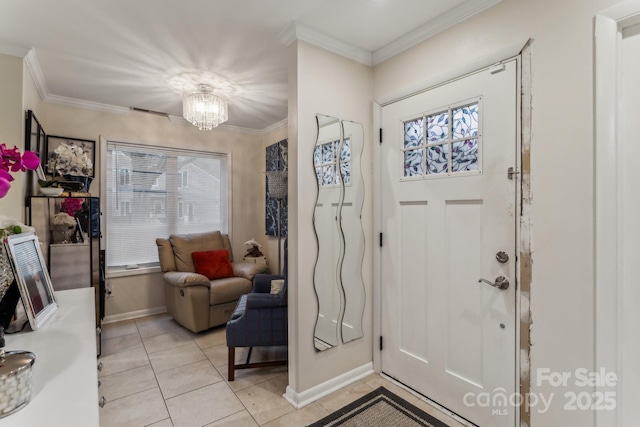 entrance foyer with an inviting chandelier, ornamental molding, and light tile patterned floors