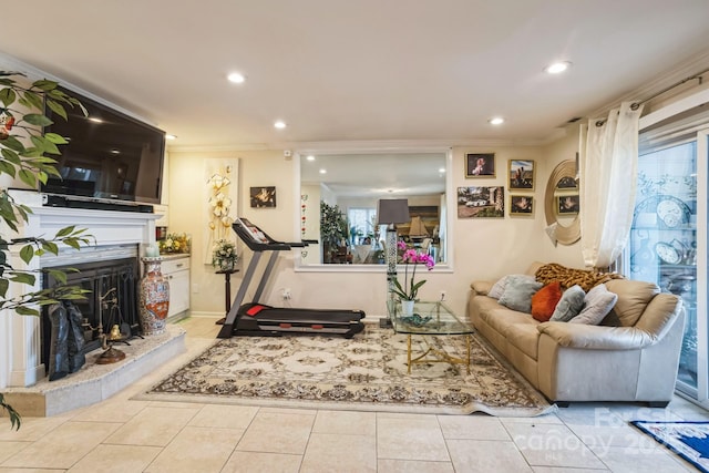 exercise area featuring ornamental molding and light tile patterned floors