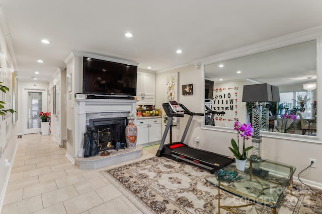 exercise area with crown molding and light tile patterned floors