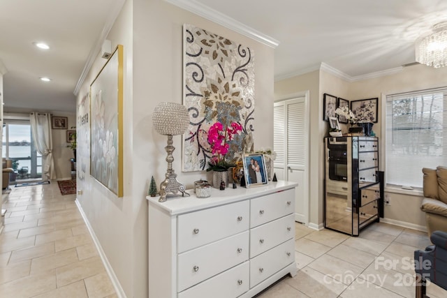 hall featuring ornamental molding, plenty of natural light, and light tile patterned floors