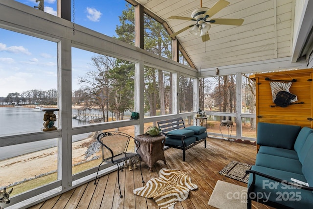 sunroom / solarium with a water view, lofted ceiling, and ceiling fan