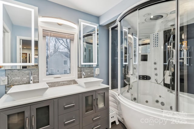 bathroom with tasteful backsplash, vanity, and bathtub / shower combination