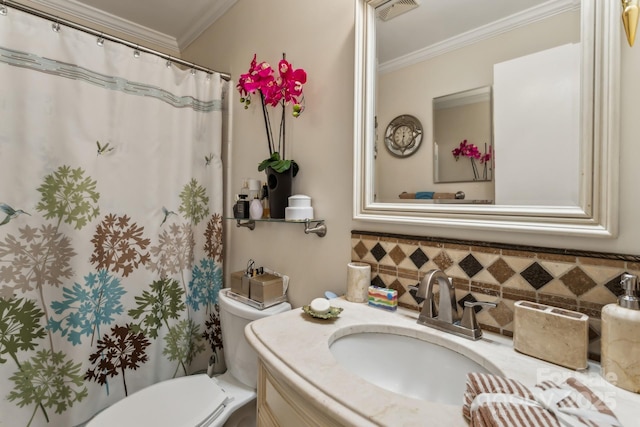 bathroom with vanity, ornamental molding, and toilet