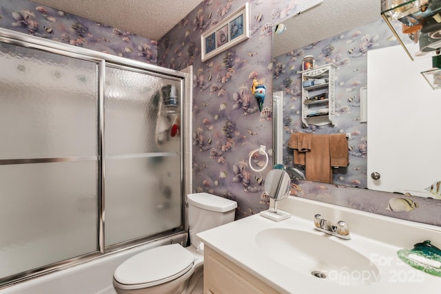 full bathroom with vanity, enclosed tub / shower combo, toilet, and a textured ceiling