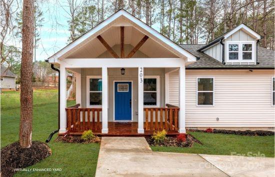 view of front of house with a front lawn and a porch