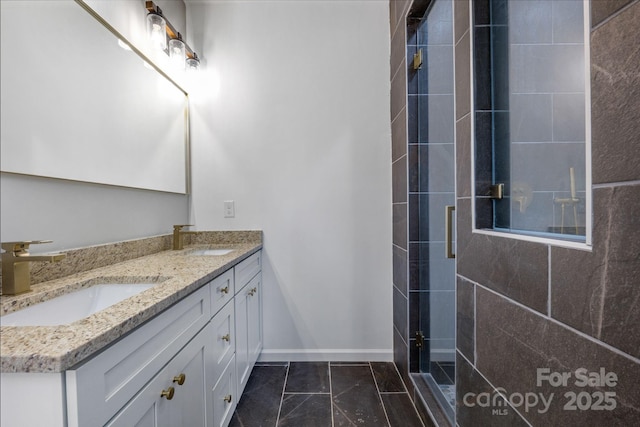 bathroom with a shower with shower door and vanity