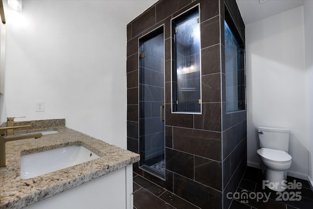 bathroom with a shower with shower door, tile patterned floors, toilet, and vanity