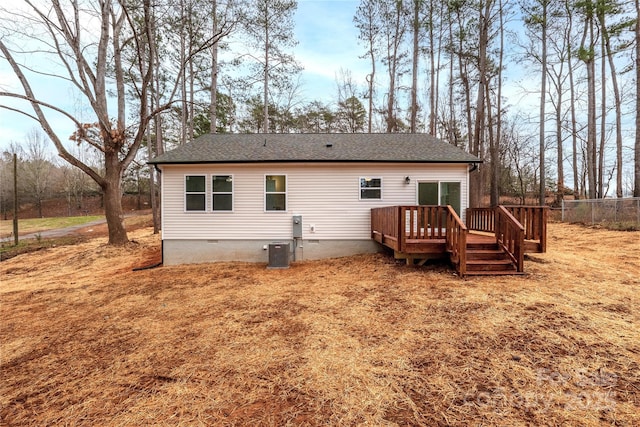 back of property with a deck and central air condition unit