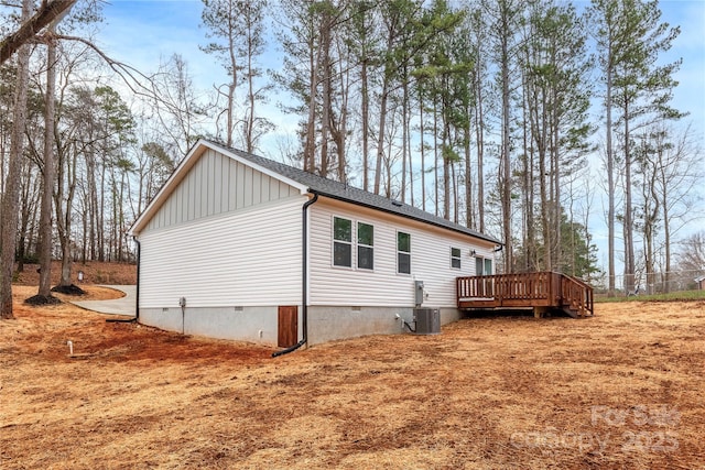 view of side of property featuring cooling unit and a wooden deck