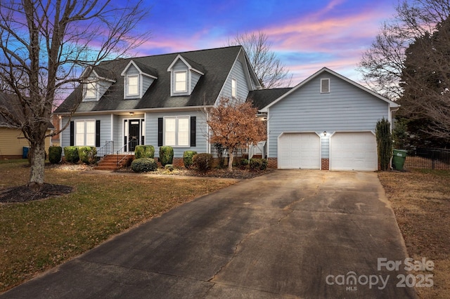 cape cod house featuring a garage