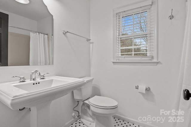 bathroom with sink, toilet, and walk in shower