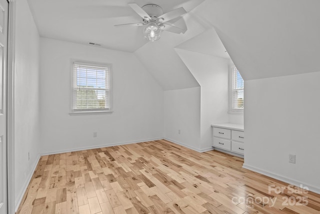 bonus room featuring light wood-type flooring, vaulted ceiling, and ceiling fan