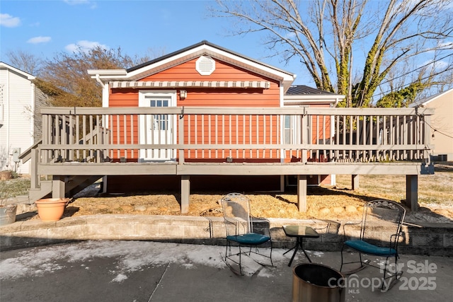 back of house with a wooden deck