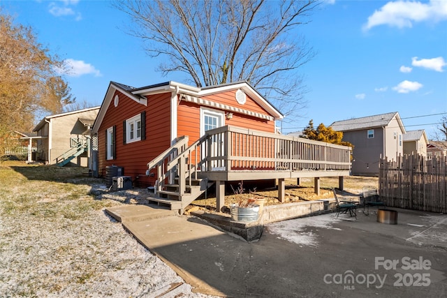 rear view of property with a patio area, a deck, and cooling unit