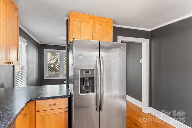 kitchen with crown molding, light hardwood / wood-style flooring, stainless steel fridge with ice dispenser, and light brown cabinetry