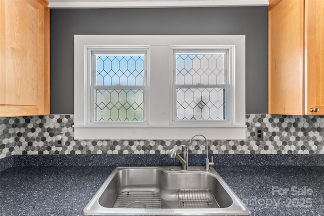 kitchen featuring sink and tasteful backsplash