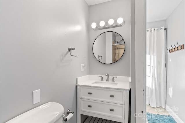 bathroom with vanity, toilet, and tile patterned flooring