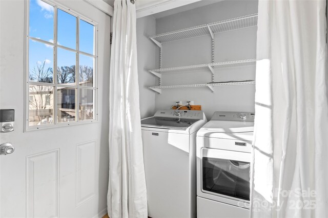 clothes washing area with washing machine and clothes dryer