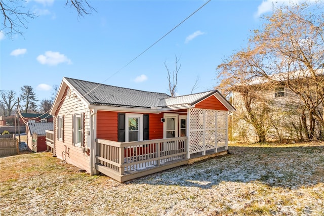 rear view of property with a yard