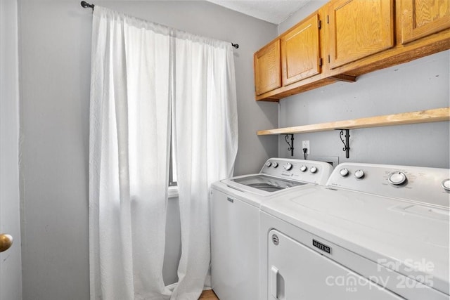 laundry area with cabinets and washing machine and dryer