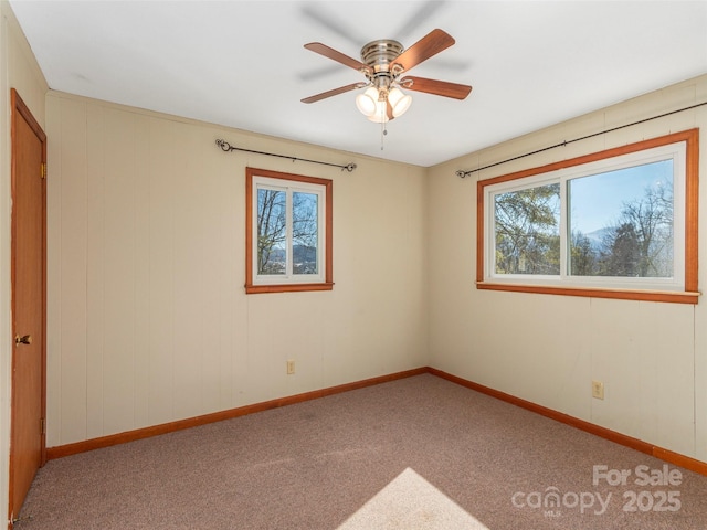 carpeted empty room featuring ceiling fan