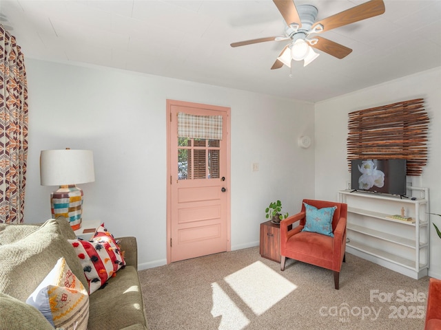 sitting room with ceiling fan and carpet