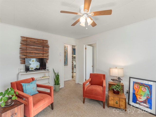 living area featuring light carpet and ceiling fan