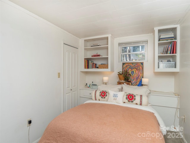 bedroom with crown molding and a closet