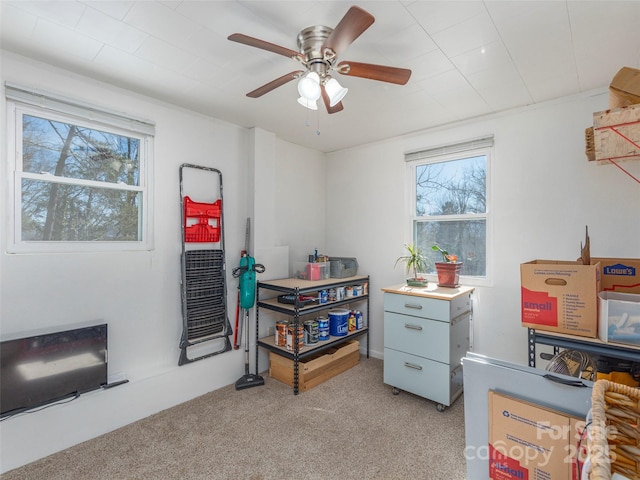 game room featuring light colored carpet and ceiling fan