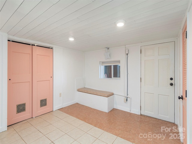 interior space with light tile patterned floors and wooden ceiling