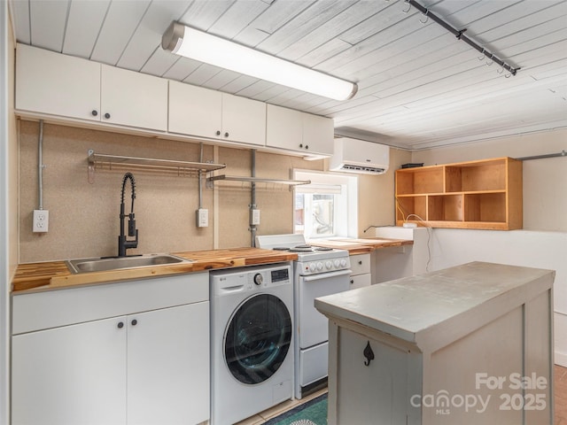 laundry area featuring washer / clothes dryer, rail lighting, an AC wall unit, and sink